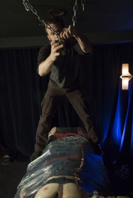 Caucasian girl is affixed to a bondage table while blindfolded and gagged 32483893
