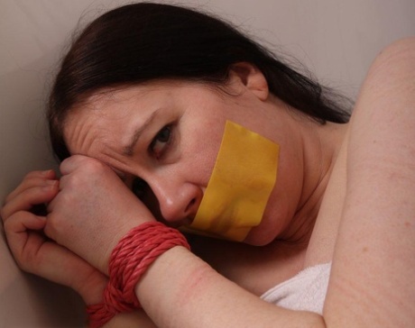 Caucasian female is left in a bathtub while gagged and bound 65943675