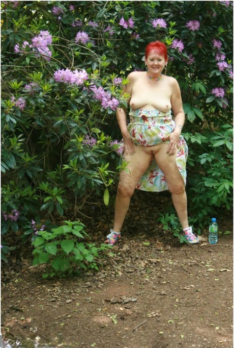 Mature redhead Valgasmic Exposed exposes herself while visiting a public park 15985603