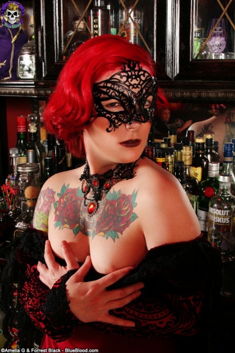Tattooed redhead Zelda gets naked while wearing a masquerade mask 78079724