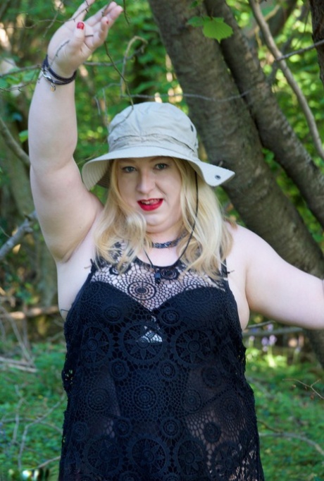 Overweight blonde gets naked by a tree while wearing a sun hat 97503357