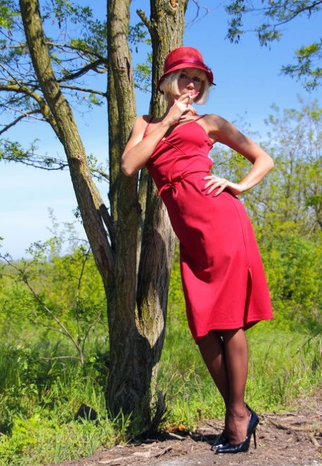 Blonde MILF exposes her tits and pussy against a tree in nylons 76670261