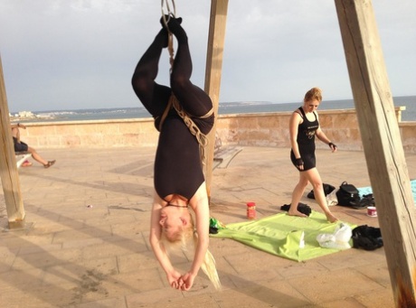 Fully clothed blond chick is suspended by ropes during outdoor bondage session 86876558
