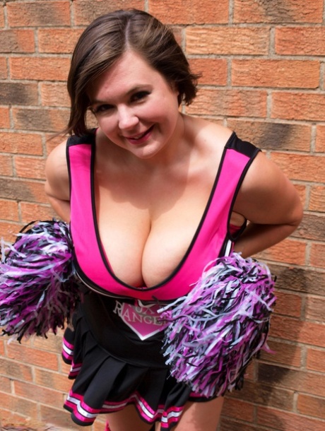 Chubby cheerleader Roxy uncovers her large tits against a brick wall 64762240