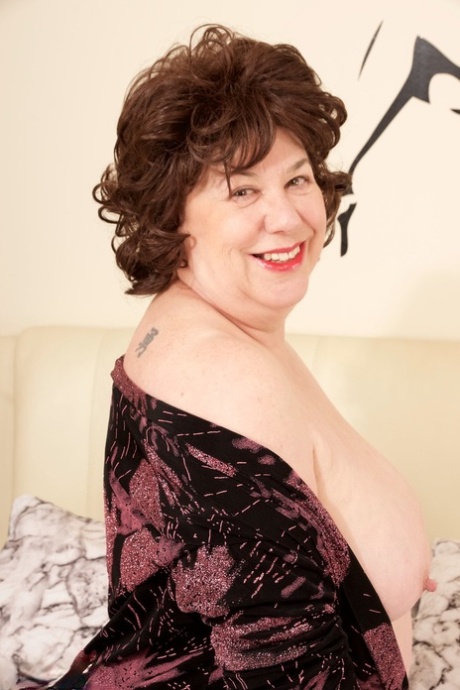 Mature plumper Dirty Doctor shows her natural tits and shaved pussy on a bed 58960156