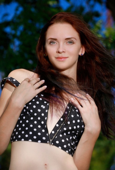 Beautiful teen Helena B gets totally naked outdoors against a tree 55377128