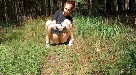 Solo girl Antonia Sainz squats for a badly needed piss on a path in the woods 16631839
