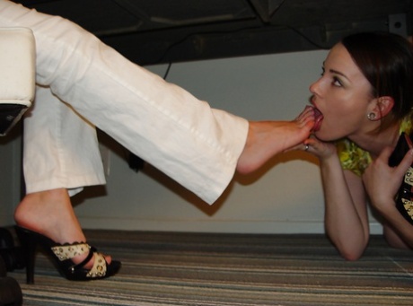 Mistress in high heels gets foot fetish worship from a girl in bondage 98761372