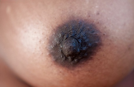 Black amateur Manuela flashing all natural tits and hairy slit outdoors 23138485