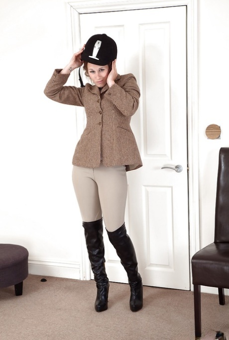 Clothed aged woman in riding boots and outfit baring hairy armpits and bush 19219636