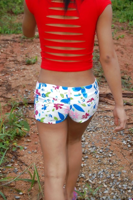 Busty young Asian ladyboy getting naked and spreading outdoors 91605785